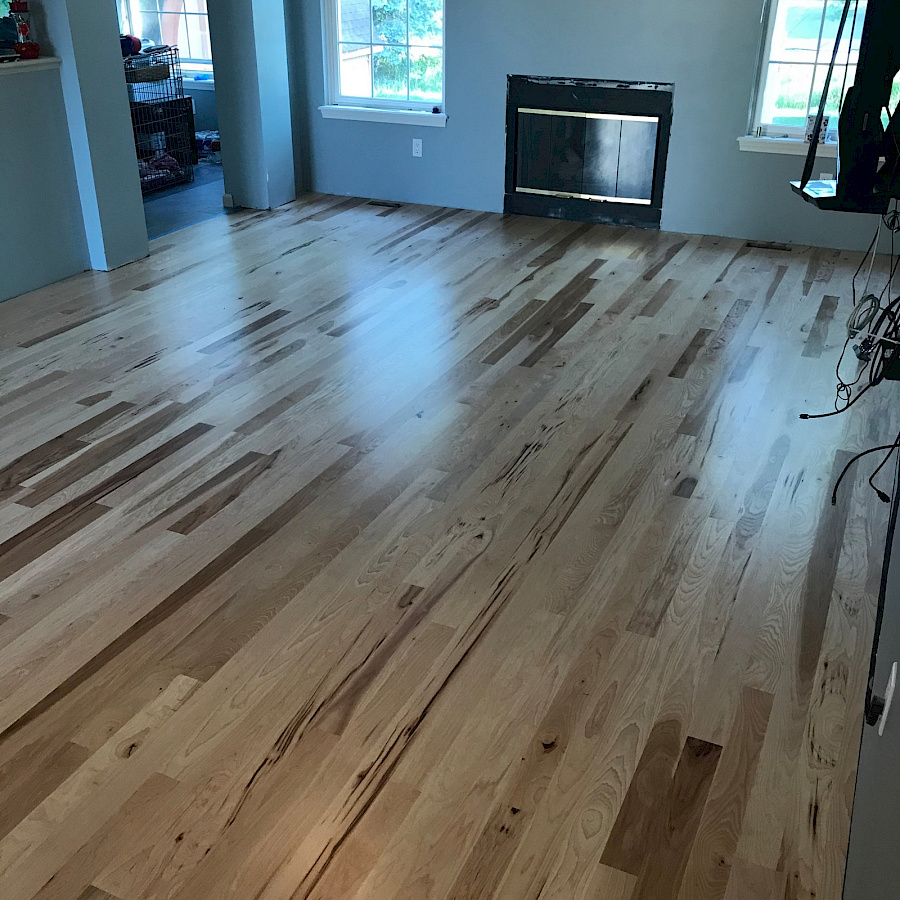 Newly installed hardwood floor in a living room by Sparrow Contracting