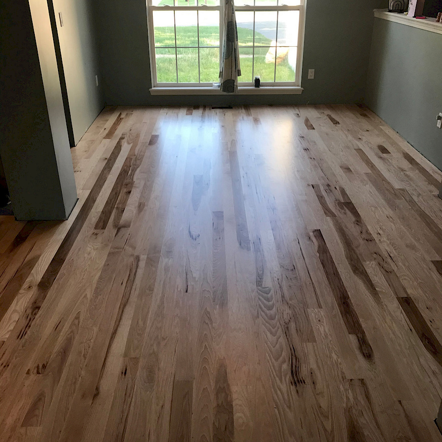 Warm toned hardwood floor installation by Sparrow Contracting