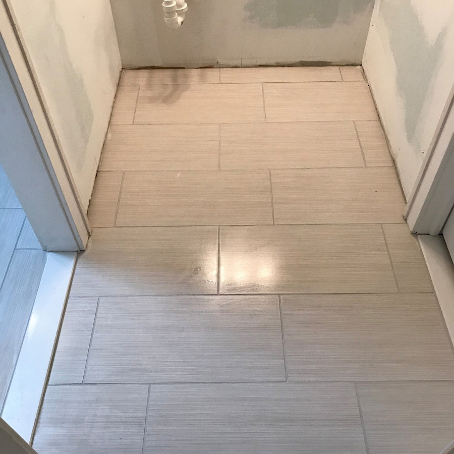 Finished tile floor in a bathroom remodel by Sparrow Contracting